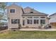 A well-maintained backyard features a patio and lots of windows providing ample light at 6470 S Oak Ct, Littleton, CO 80127