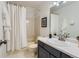 Bathroom featuring a shower/tub, white tile, and a sink with vanity at 6470 S Oak Ct, Littleton, CO 80127