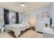 Bedroom featuring a bed, a dresser, and wall art at 6470 S Oak Ct, Littleton, CO 80127