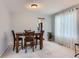 Cozy dining area with a wooden table set, neutral walls, and a view into the kitchen, perfect for Gathering meals at 6470 S Oak Ct, Littleton, CO 80127