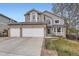 Charming two-story home with a well-manicured lawn and a three-car garage at 6470 S Oak Ct, Littleton, CO 80127