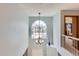 Foyer featuring a light fixture, a railing, and an arched window at 6470 S Oak Ct, Littleton, CO 80127