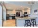 Updated kitchen featuring granite countertops, modern appliances, and eat-in breakfast bar at 6470 S Oak Ct, Littleton, CO 80127
