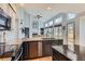 Open kitchen design with an island, granite countertops, and a seamless transition to the living area with a fireplace at 6470 S Oak Ct, Littleton, CO 80127