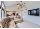 Open-concept living room showcasing vaulted ceilings, a kitchen view, and natural light at 6470 S Oak Ct, Littleton, CO 80127