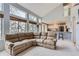 Bright living room boasts soaring ceilings, large windows, and open-concept design with kitchen view at 6470 S Oak Ct, Littleton, CO 80127
