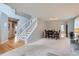 Open living space featuring hardwood floors, neutral carpet, and an open staircase, blending comfort and style at 6470 S Oak Ct, Littleton, CO 80127