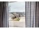 Neighborhood view through a window with grey curtains at 6470 S Oak Ct, Littleton, CO 80127