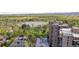 High-rise building near large pond and park with lush green trees in a suburban environment at 480 S Marion Pkwy # 802, Denver, CO 80209