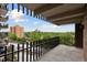 Condo balcony with black metal railing offering city and treeline views at 480 S Marion Pkwy # 802, Denver, CO 80209