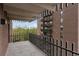 Brick condo exterior featuring a balcony with steel railing and a treeline view at 480 S Marion Pkwy # 802, Denver, CO 80209