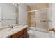 Well-lit bathroom featuring a tiled shower and tub combination, vanity with modern fixtures and marble countertop at 480 S Marion Pkwy # 802, Denver, CO 80209