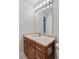 Bathroom with a wood vanity, marble countertop, updated lighting, and ample storage space at 480 S Marion Pkwy # 802, Denver, CO 80209