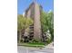 Exterior view of high-rise building featuring balconies, trees, and manicured landscaping at 480 S Marion Pkwy # 802, Denver, CO 80209