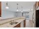 Granite countertops with a sink and a dishwasher. Balcony access on the right side at 480 S Marion Pkwy # 802, Denver, CO 80209