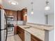 Bright kitchen featuring a breakfast bar with granite countertops and ample cabinet space at 480 S Marion Pkwy # 802, Denver, CO 80209