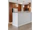 Spacious kitchen island with bar, stainless steel appliances, and sleek wooden cabinets at 480 S Marion Pkwy # 802, Denver, CO 80209