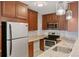 Modern kitchen with stainless steel appliances, granite countertops, and wood cabinets at 480 S Marion Pkwy # 802, Denver, CO 80209