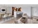 Stylish living room with contemporary furniture and a dining area with a bar and kitchen in the background at 480 S Marion Pkwy # 802, Denver, CO 80209
