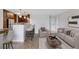 Comfortable living room with a kitchen area featuring barstool seating and an entrance to a hallway at 480 S Marion Pkwy # 802, Denver, CO 80209