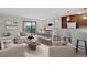 Open-concept living room with modern furnishings and a sliding glass door to a balcony with views at 480 S Marion Pkwy # 802, Denver, CO 80209