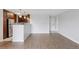 Bright living room featuring wood floors, modern lighting, and updated kitchen appliances at 480 S Marion Pkwy # 802, Denver, CO 80209