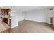 Bright living room featuring wood floors, modern lighting, and updated kitchen at 480 S Marion Pkwy # 802, Denver, CO 80209
