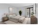 A serene main bedroom featuring a bed, nightstands, and balcony access at 480 S Marion Pkwy # 802, Denver, CO 80209