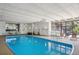 Bright indoor swimming pool area features clear blue water, seating, and large windows at 480 S Marion Pkwy # 802, Denver, CO 80209