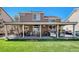 Large backyard with a covered patio, seating area, BBQ, and ample green space at 19681 E 59Th Pl, Aurora, CO 80019