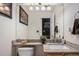 Bathroom featuring granite countertops, a decorative mirror, and updated fixtures, creating a modern and inviting space at 19681 E 59Th Pl, Aurora, CO 80019