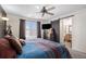 Bright bedroom with a ceiling fan, natural light, and a barn door leading to the en-suite bathroom at 19681 E 59Th Pl, Aurora, CO 80019