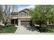 Charming two-story home with a well-manicured lawn and a two-car garage at 19681 E 59Th Pl, Aurora, CO 80019