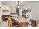 Open kitchen with an island, modern lighting, and seamless flow to living areas at 19681 E 59Th Pl, Aurora, CO 80019