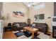 Cozy living room with high ceilings, comfortable seating, and a decorative fireplace at 19681 E 59Th Pl, Aurora, CO 80019