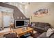 Bright living room with high ceilings, a staircase, and a cozy seating area at 19681 E 59Th Pl, Aurora, CO 80019