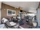 Inviting covered patio featuring comfortable seating, ceiling fans, and outdoor dining area at 19681 E 59Th Pl, Aurora, CO 80019