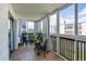 Enclosed balcony featuring tile flooring, large windows, and cozy seating at 3465 S Poplar St # 506, Denver, CO 80224