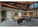 Game room features billiard tables, a high ceiling with exposed wood beams, and natural light at 3465 S Poplar St # 506, Denver, CO 80224