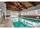 Bright indoor pool with large windows and tiled walls, perfect for year-round enjoyment at 3465 S Poplar St # 506, Denver, CO 80224