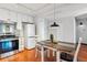 Bright kitchen featuring white cabinets and appliances, and track lighting over hardwood floors at 3465 S Poplar St # 506, Denver, CO 80224