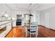 A compact kitchen with stainless steel appliances, and white cabinets over hardwood floors at 3465 S Poplar St # 506, Denver, CO 80224