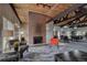 Common area with a brick fireplace, wood beamed ceiling, and comfortable seating arrangements at 3465 S Poplar St # 506, Denver, CO 80224