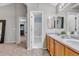 Neutral bathroom with a double sink vanity, and door to the toilet/shower area at 4112 Brandon Ave, Broomfield, CO 80020