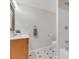 Bathroom features white bathtub shower, wooden vanity, and decorative tile flooring at 4112 Brandon Ave, Broomfield, CO 80020
