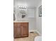 Bathroom with single vanity sink, neutral countertop, and stylish circular mirror at 4112 Brandon Ave, Broomfield, CO 80020