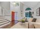 Bright foyer with high ceilings, a striking orange front door, and an open staircase leading to the upper level at 4112 Brandon Ave, Broomfield, CO 80020