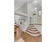 Staircase with hardwood flooring, neutral walls, and natural light from entryway door at 4112 Brandon Ave, Broomfield, CO 80020