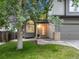 Inviting home entrance with a manicured lawn, stone accents, and a cozy porch enhanced by a flower pot at 4112 Brandon Ave, Broomfield, CO 80020