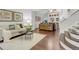 Open-concept living area with a comfortable sofa, stylish decor, hardwood floors and staircase at 4112 Brandon Ave, Broomfield, CO 80020